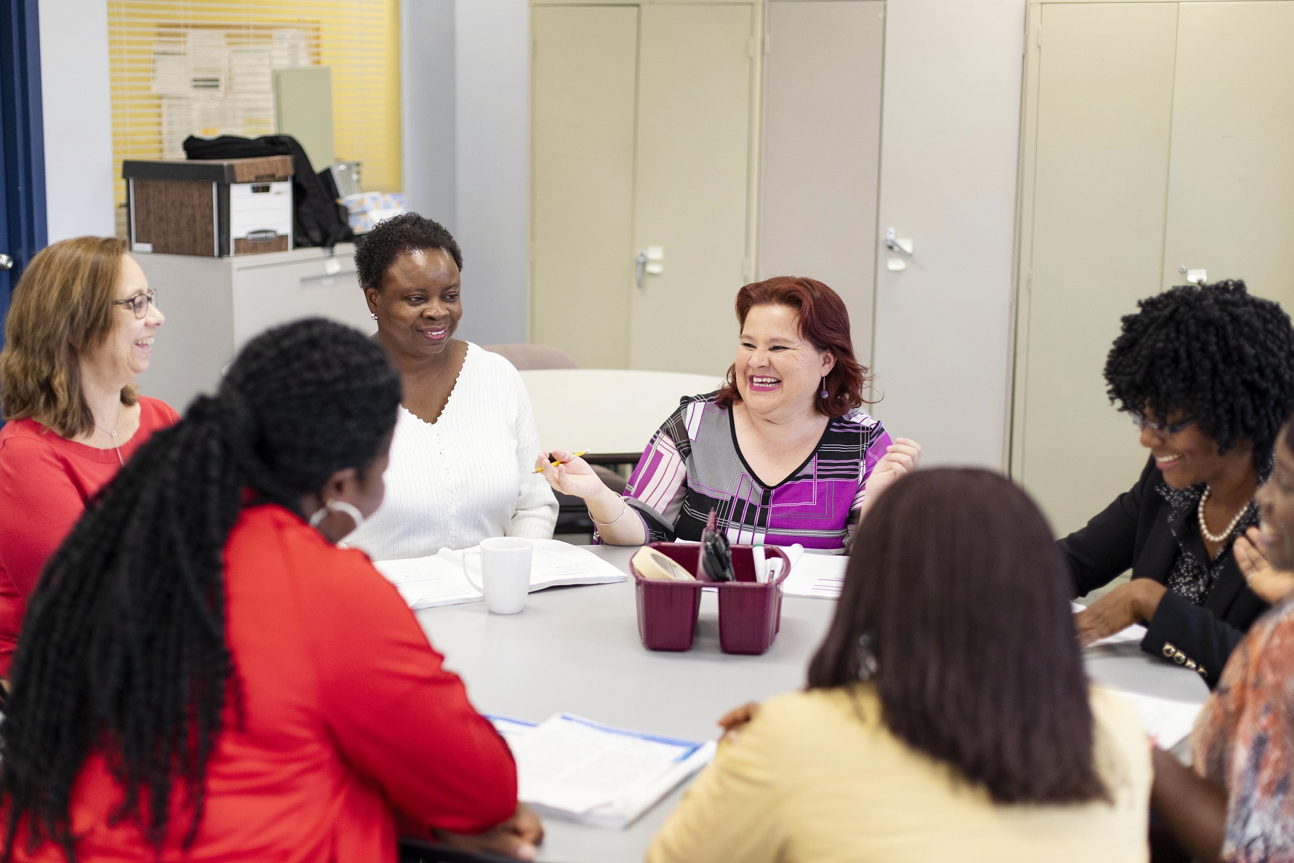 Laughing women round table