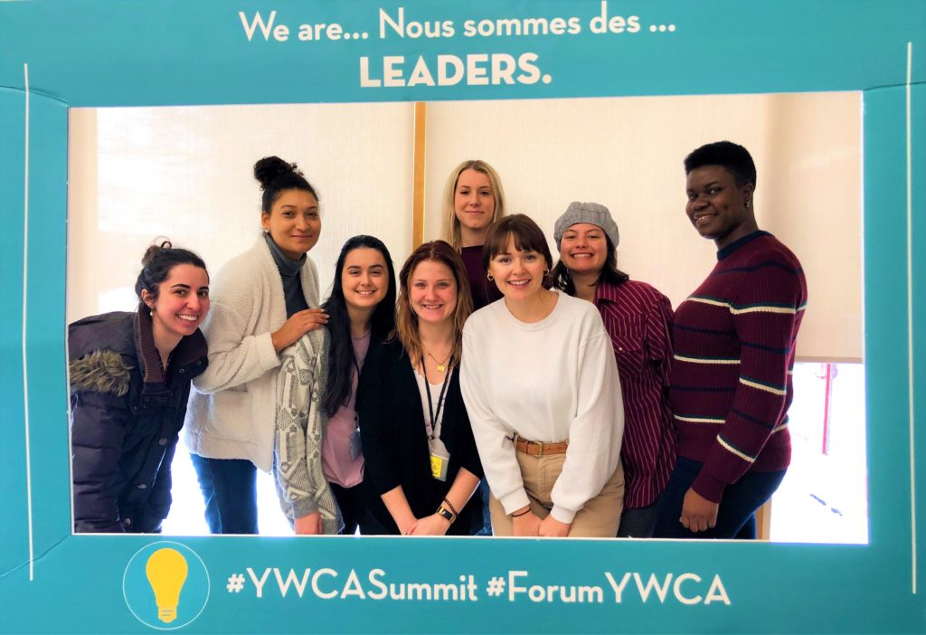 Eight young women smiling in a frame that reads, "We are leaders."